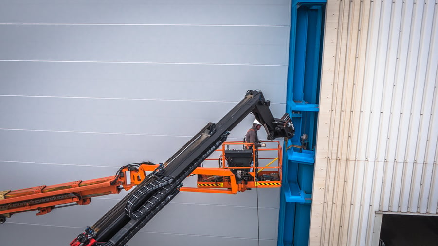 Champion Door technicians installing a large fabric door from a lift