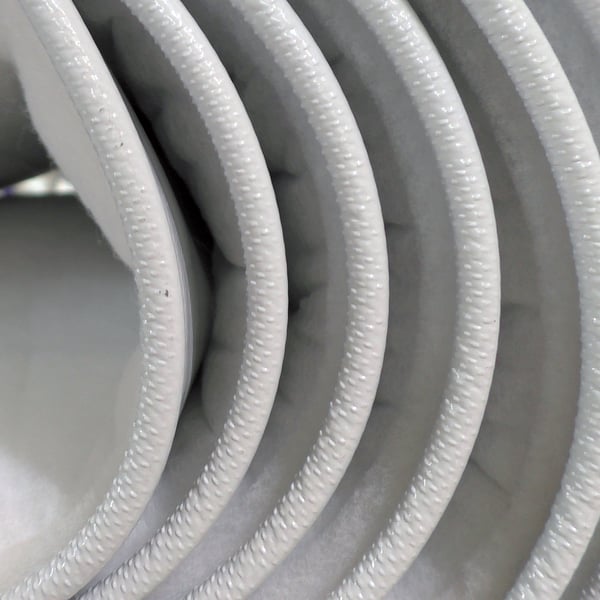 Folded layers of thermally insulated Champion Door fabric