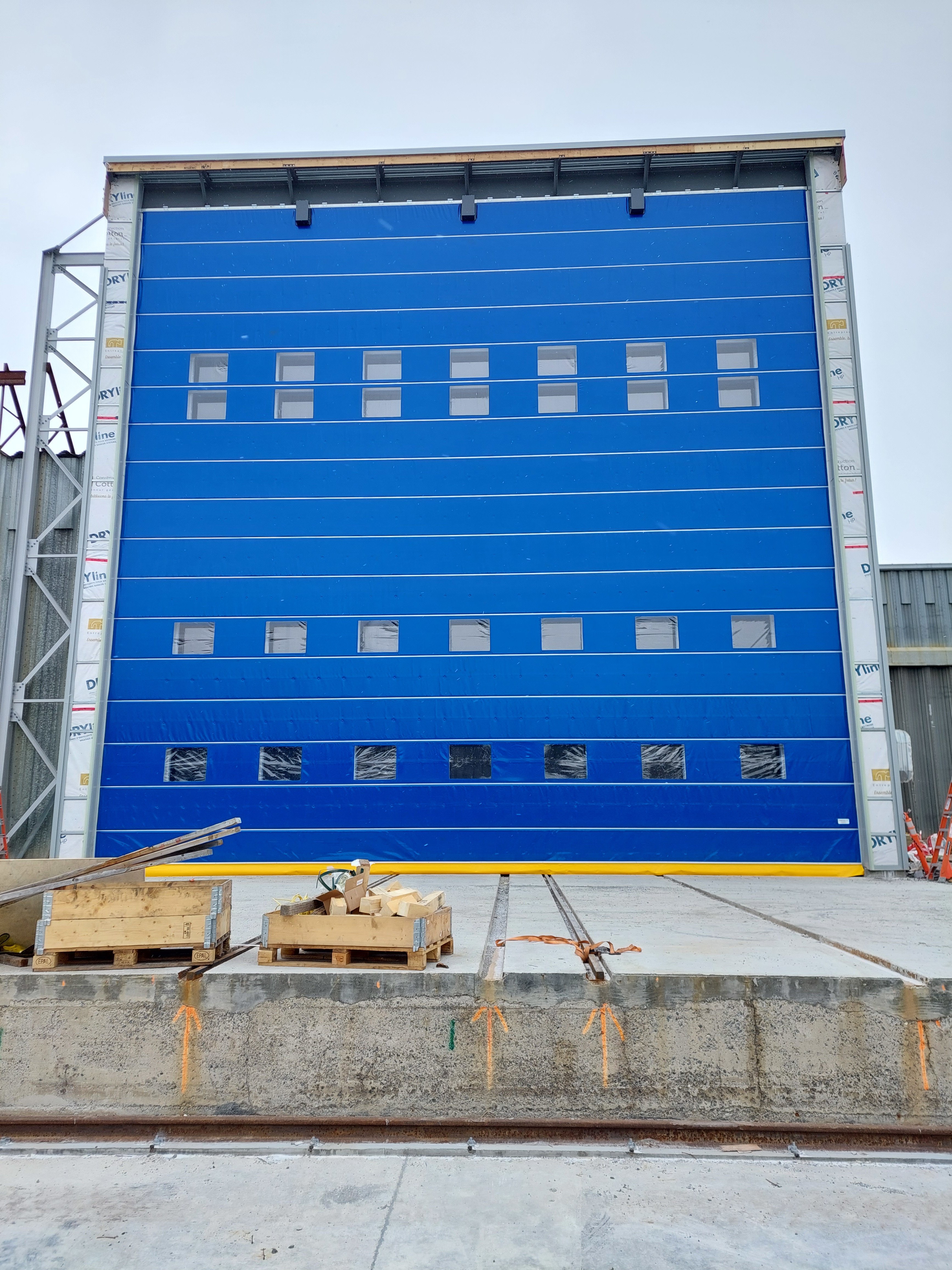 Thermally insulated fabric fold-up door at shipyard